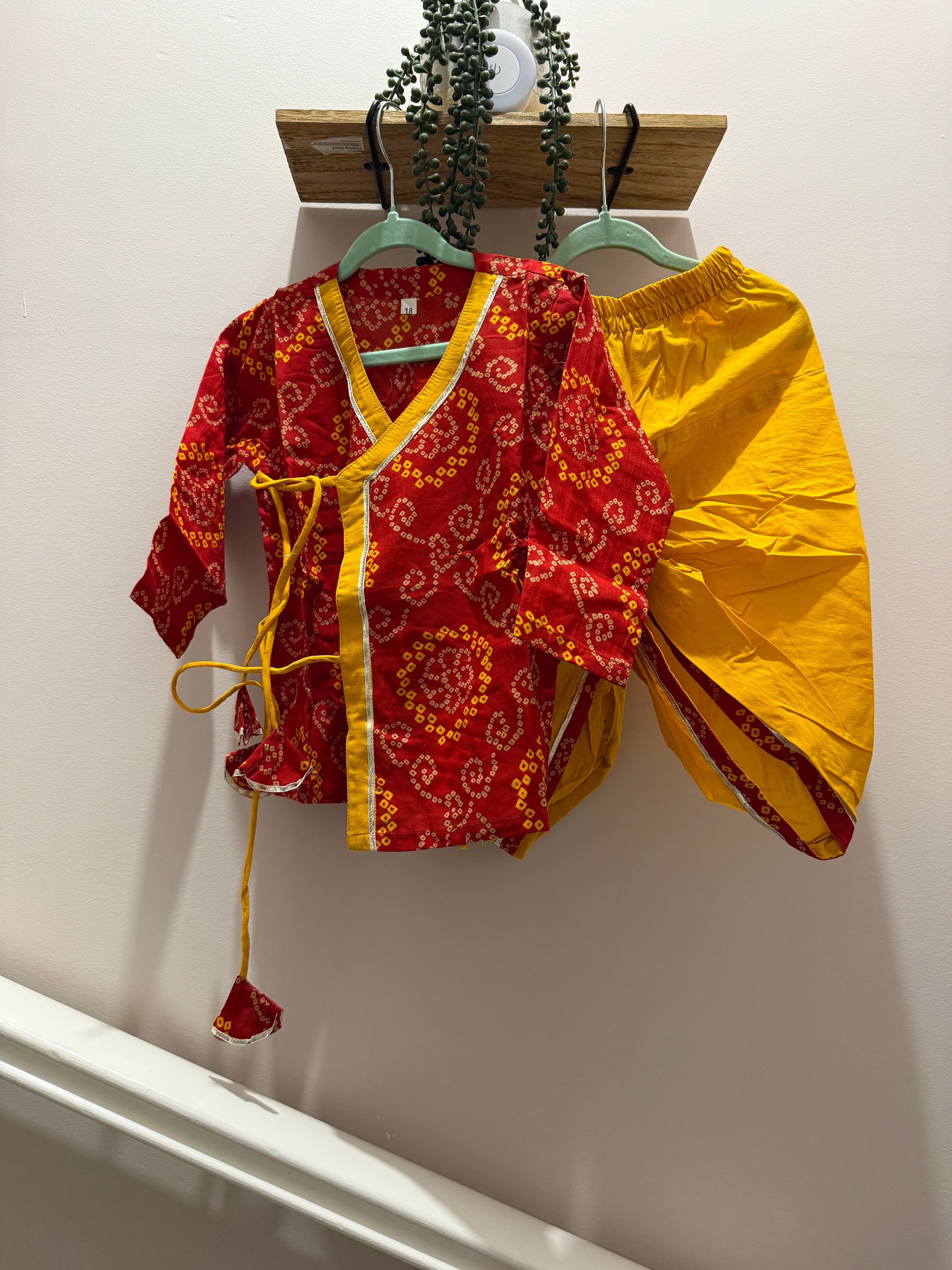 Red and yellow boy's kurta with bandhani pattern and yellow dhoti pants for festive wear
